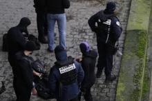 Des membres de la brigade fluviale de Paris attendent sur les berges de la Seine le résultat des recherches, après la disparition d'une policière lors d'un exercice en fin de matinée, le 5 janvier 201