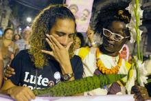 Anielle Silva (L), sister of activist Marielle Franco, cries at a memorial in Rio de Janeiro on April 14, 2018, one month after Franco's murder