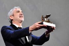La 75e Mostra de Venise décerne, le 8 septembre 2018, son "Lion d'or du meilleur film" au réalisateur mexicain Alfonso Cuaron (C) pour "Roma", un film distribué par Netflix.