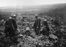 (FILES) - A picture taken in 1916 shows Poilus, French World War I infantrymen, taking care of wounded soldiers on a battlefield after an attack during the Verdun battle, eastern France, during the fi
