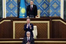 Le président du Kazakhstan par intérim Kassym-Jomart Tokaïev (bas) et l'ancien chef d'Etat Noursultan Nazarbaïev (haut) devant les parlementaires à Astana, le 20 mars 2019