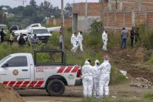 Forensic and civil protection personnel work at a clandestine grave where local authorities have found at least 16 bodies, in Agua Escondida neighborhood,in Tonala, Jalisco state, Mexico, in October 2