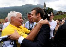Le président de la République, Emmanuel Macron (d), salue l'ancien cycliste Raymond Poulidor, à l'arrivée de la 17e étape du Tour de France 2017, à Saint-Martin-d'Arc, le 19 juillet