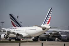 Des avions à l'arrêt sur le tarmac de l'aéroport de Roissy, au nord de Paris, le 24 mars 2020