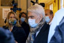 French businessman Bernard Tapie (C) arrives at the "Palais de Justice" courthouse in Paris on October 12, 2020, on the first day of his and five other defendants' retrial on charges of "fraud" over a