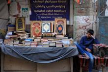 A Yemeni vendor sells copies of the Koran at a market in the old city of the Yemeni capital Sanaa on the first day of the Muslim holy month of Ramadan, on April 2, 2022.