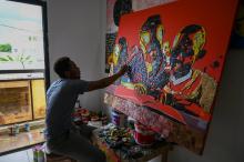 L'artiste vorien Mounou Désiré Koffi réalise une toile avec des claviers de téléphone usagés dans sa résidence de Bingerville, une commune d'Abidjan, le 28 avril 2022